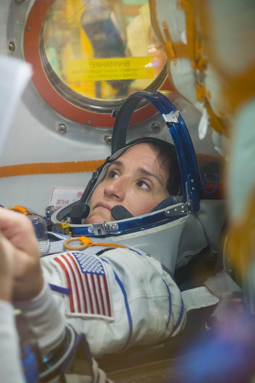 jsc2018e050005 - In the Integration Facility at the Baikonur Cosmodrome in Kazakhstan, Expedition 56 crewmember Serena Aunon-Chancellor of NASA runs through procedures May 20 in the Soyuz MS-09 spacecraft as part of the first fit check dress rehearsal activities. Aunon-Chancellor, Sergey Prokopyev of Roscosmos and Alexander Gerst of the European Space Agency will launch June 6 on the Soyuz MS-09 spacecraft from Baikonur for a six-month mission on the International Space Station...NASA/Victor Zelentsov.