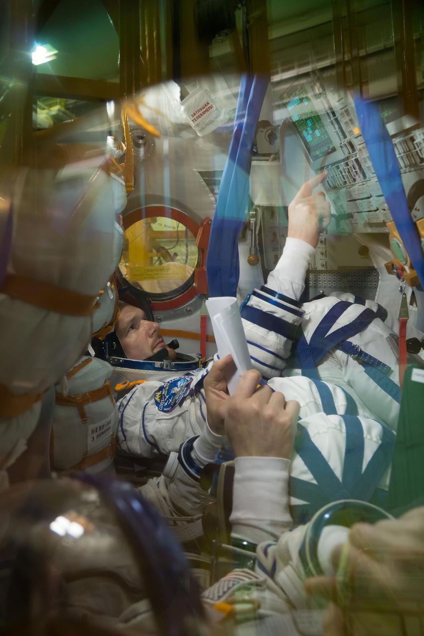 jsc2018e050006 - In the Integration Facility at the Baikonur Cosmodrome in Kazakhstan, Expedition 56 crewmember Alexander Gerst of the European Space Agency runs through procedures May 20 in the Soyuz MS-09 spacecraft as part of the first fit check dress rehearsal activities. Gerst, Serena Aunon-Chancellor of NASA and Sergey Prokopyev of Roscosmos will launch June 6 on the Soyuz MS-09 spacecraft from Baikonur for a six-month mission on the International Space Station...NASA/Victor Zelentsov.