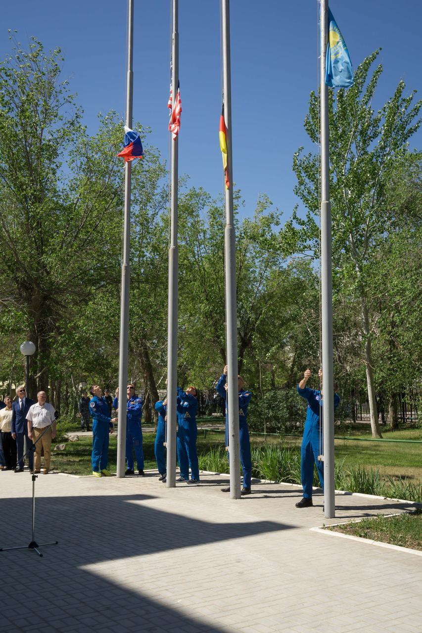At their Cosmonaut Hotel crew quarters in Baikonur, Kazakhstan, the Expedition 56 prime and backup crewmembers raise the flags of the U.S., Russia, Germany and Kazakhstan May 21 in traditional pre-launch ceremonies. Serena Aunon-Chancellor of NASA, Sergey Prokopyev of Roscosmos and Alexander Gerst of the European Space Agency will launch June 6 on the Soyuz MS-09 spacecraft from Baikonur for a six-month mission on the International Space Station...NASA/Victor Zelentsov.