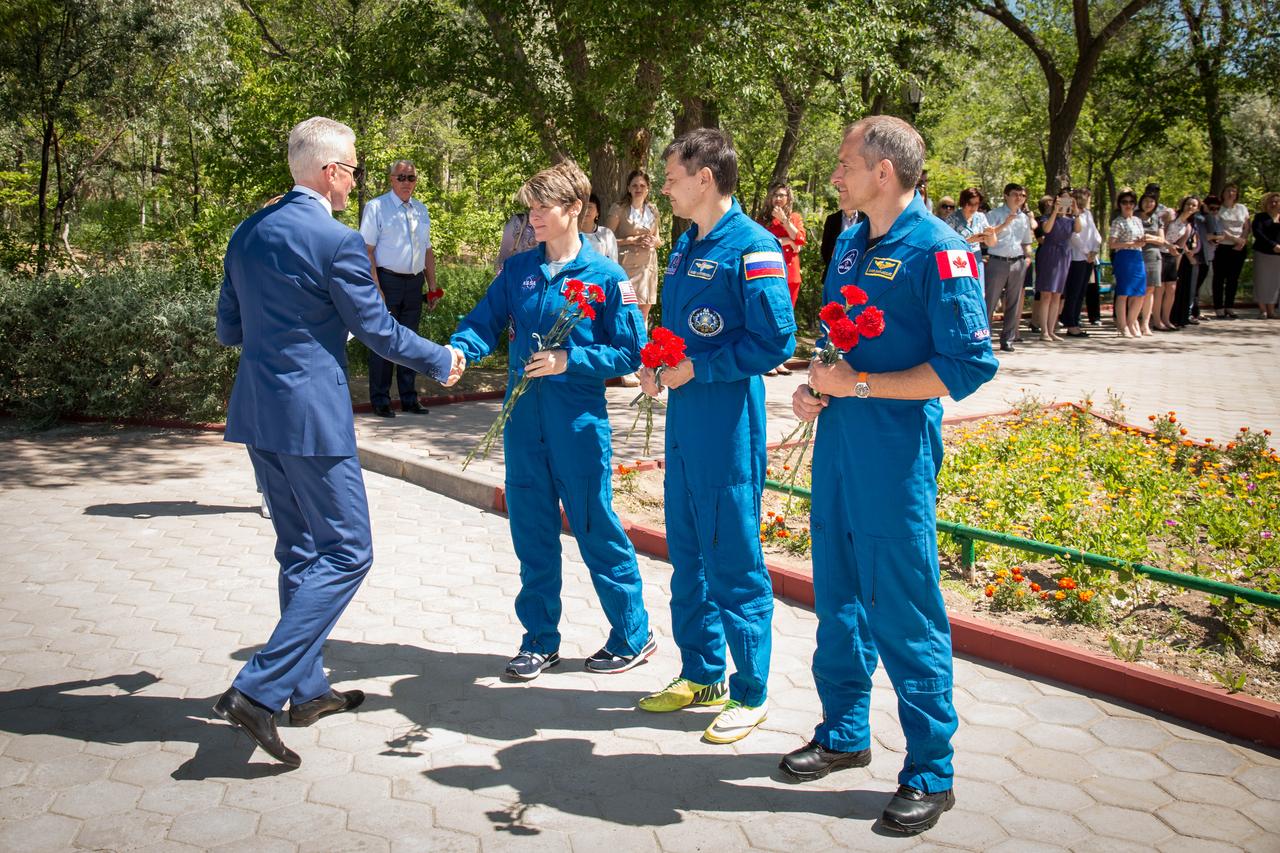 jsc2018e050014 - At their Cosmonaut Hotel crew quarters in Baikonur, Kazakhstan, Expedition 56 backup crewmembers Anne McClain of NASA, Oleg Kononenko of Roscosmos and David Saint-Jacques of the Canadian Space Agency receive a gift of flowers and congratulations from local officials May 21 as part of their pre-launch activities. They are the backups to the prime crew, Serena Aunon-Chancellor of NASA, Sergey Prokopyev of Roscosmos and Alexander Gerst of the European Space Agency, who will launch June 6 on the Soyuz MS-09 spacecraft from Baikonur for a six-month mission on the International Space Station...NASA/Victor Zelentsov.