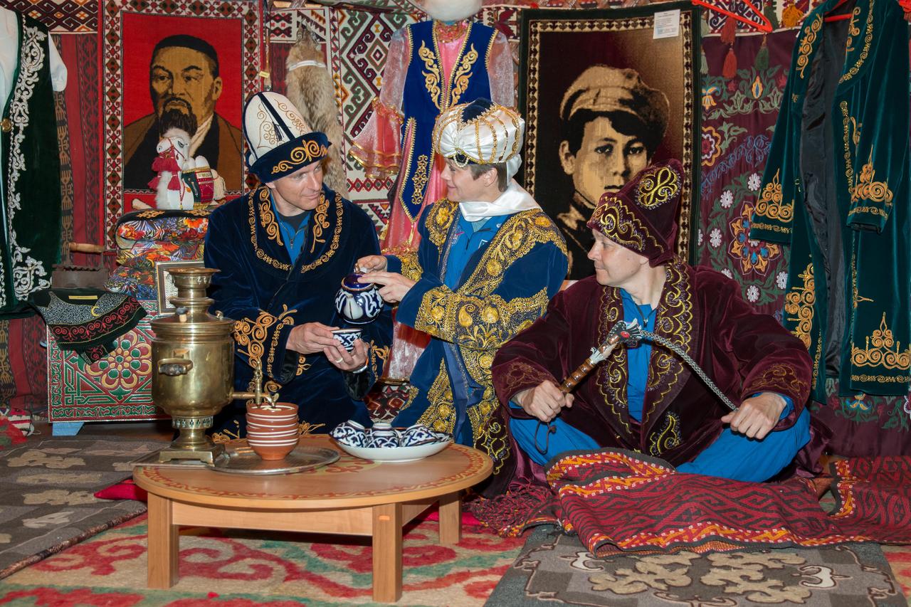jsc2018e050023 - At the Baikonur Museum in Baikonur, Kazakhstan, Expedition 56 backup crewmembers David Saint-Jacques of the Canadian Space Agency (left), Anne McClain of NASA (center) and Oleg Kononenko of Roscosmos (right) enjoy a cup of tea May 21 in a model of a “yurt”, a traditional Kazakh tent, during pre-launch activities. They are the backups to the prime crewmembers, Serena Aunon-Chancellor of NASA, Sergey Prokopyev of Roscosmos and Alexander Gerst of the European Space Agency, who will launch June 6 on the Soyuz MS-09 spacecraft from Baikonur for a six-month mission on the International Space Station...NASA/Victor Zelentsov.