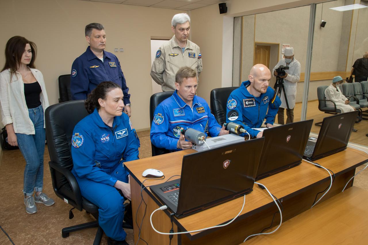 jsc2018e050820 - At the Cosmonaut Hotel crew quarters in Baikonur, Kazakhstan, Expedition 56 crewmembers Serena Aunon-Chancellor of NASA (left), Sergey Prokopyev of Roscosmos (center) and Alexander Gerst of the European Space Agency (right) conduct rendezvous and docking procedures on a laptop training simulator May 29 as part of their pre-launch preparations. Aunon-Chancellor, Prokopyev and Gerst will launch June 6 from the Baikonur Cosmodrome in Kazakhstan on the Soyuz MS-09 spacecraft for a six-month mission on the International Space Station...NASA/Victor Zelentsov.
