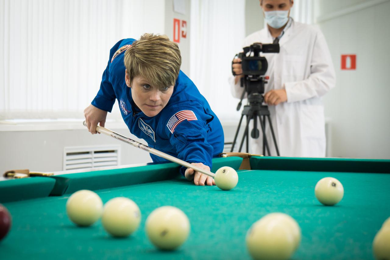 jsc2018e050824 - At the Cosmonaut Hotel crew quarters in Baikonur, Kazakhstan, Expedition 56 backup crewmember Anne McClain of NASA tries her hand at a game of billiards May 29 as part of the traditional pre-launch activities. She is one of the backups to the prime crew, Serena Aunon-Chancellor of NASA, Sergey Prokopyev of Roscosmos and Alexander Gerst of the European Space Agency, who will launch June 6 from the Baikonur Cosmodrome in Kazakhstan on the Soyuz MS-09 spacecraft for a six-month mission on the International Space Station...NASA/Victor Zelentsov.