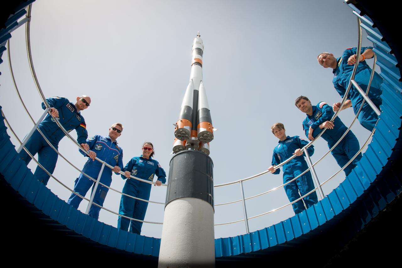 jsc2018e050836 - At the Cosmonaut Hotel crew quarters in Baikonur, Kazakhstan, the Expedition 56 prime and backup crewmembers pose for pictures May 29 flanking a model of a Soyuz rocket. From left to right are the prime crewmembers, Alexander Gerst of the European Space Agency, Sergey Prokopyev of Roscosmos and Serena Aunon-Chancellor of NASA and their backups, Anne McClain of NASA, Oleg Kononenko of Roscosmos and David Saint-Jacques of the Canadian Space Agency. Aunon-Chancellor, Prokopyev and Gerst will launch June 6 from the Baikonur Cosmodrome in Kazakhstan on the Soyuz MS-09 spacecraft for a six-month mission on the International Space Station...NASA/Victor Zelentsov.