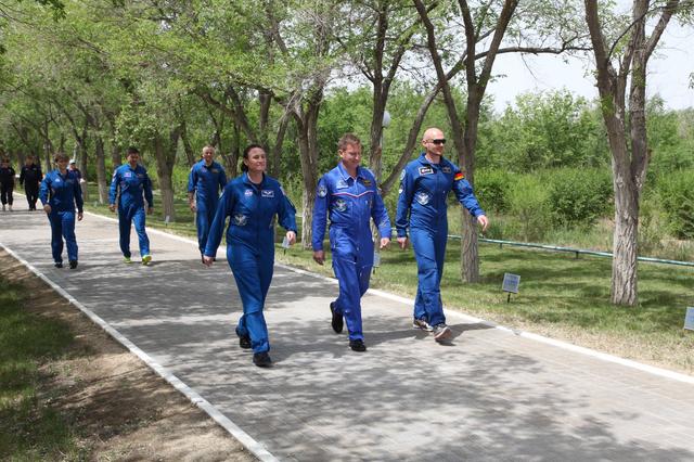 jsc2018e050838 - At the Cosmonaut Hotel crew quarters in Baikonur, Kazakhstan, Expedition 56 crewmembers Serena Aunon-Chancellor of NASA (front row, left), Sergey Prokopyev of Roscosmos (center) and Alexander Gerst of the European Space Agency (right) take a stroll down the Walk of Cosmonauts May 29 as part of their traditional pre-launch activities. Behind them are the backup crewmembers, Anne McClain of NASA, Oleg Kononenko of Roscosmos and David Saint-Jacques of the Canadian Space Agency. Aunon-Chancellor, Prokopyev and Gerst will launch June 6 from the Baikonur Cosmodrome in Kazakhstan on the Soyuz MS-09 spacecraft for a six-month mission on the International Space Station...Andrey Shelepin/Gagarin Cosmonaut Training Center.