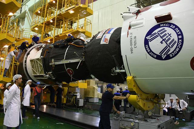 jsc2018e050839 - In the Integration Facility at the Baikonur Cosmodrome in Kazakhstan, the Soyuz MS-09 spacecraft is inserted into the upper stage of its Soyuz booster rocket May 29. Serena Aunon-Chancellor of NASA, Alexander Gerst of the European Space Agency and Sergey Prokopyev of Roscosmos will launch June 6 from the Baikonur Cosmodrome on the Soyuz MS-09 spacecraft for a six-month mission on the International Space Station...Courtesy: Roscosmos and RSC-Energia.