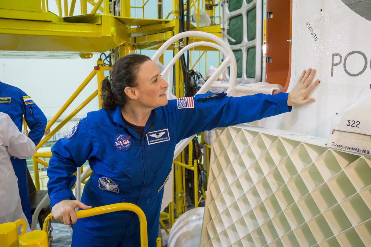 jsc2018e051929 - In the Integration Facility at the Baikonur Cosmodrome in Kazakhstan, Expedition 56 crewmember Serena Aunon-Chancellor of NASA touches the fairing of her Soyuz spacecraft May 31 during a final inspection. Aunon-Chancellor, Alexander Gerst of the European Space Agency and Sergey Prokopyev of Roscosmos will launch June 6 in the Soyuz MS-09 spacecraft for a six-month mission on the International Space Station. ..NASA/Victor Zelentsov.