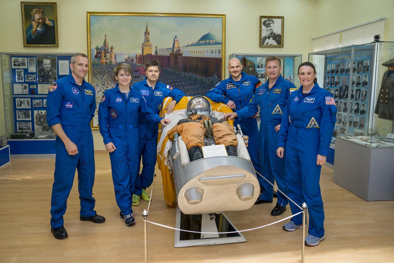 jsc2018e051932 - In the Korolev Museum at the Baikonur Cosmodrome in Kazakhstan, the Expedition 56 prime and backup crews pose for pictures May 31 flanking a model of a Soyuz crewmember strapped in their seat. From left to right are the backup crewmembers, David Saint-Jacques of the Canadian Space Agency, Anne McClain of NASA and Oleg Kononenko of Roscosmos and the prime crew. Alexander Gerst of the European Space Agency, Sergey Prokopyev of Roscosmos and Serena Aunon-Chancellor of NASA. Aunon-Chancellor, Prokopyev and Gerst will launch June 6 in the Soyuz MS-09 spacecraft for a six-month mission on the International Space Station. ..NASA/Victor Zelentsov.