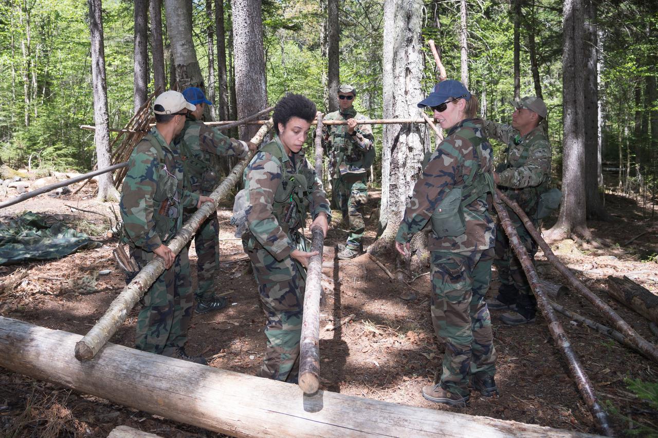 jsc2018e052153 (May 30, 2018) --- 2017 NASA astronaut candidate Jessica Watkins preps her station with fellow candidate Loral O’Hara looking on during wilderness survival training at the U.S. Navy’s Survival, Evasion, Resistance, and Escape School in Brunswick, Maine. Photo Credit: (NASA/Josh Valcarcel)