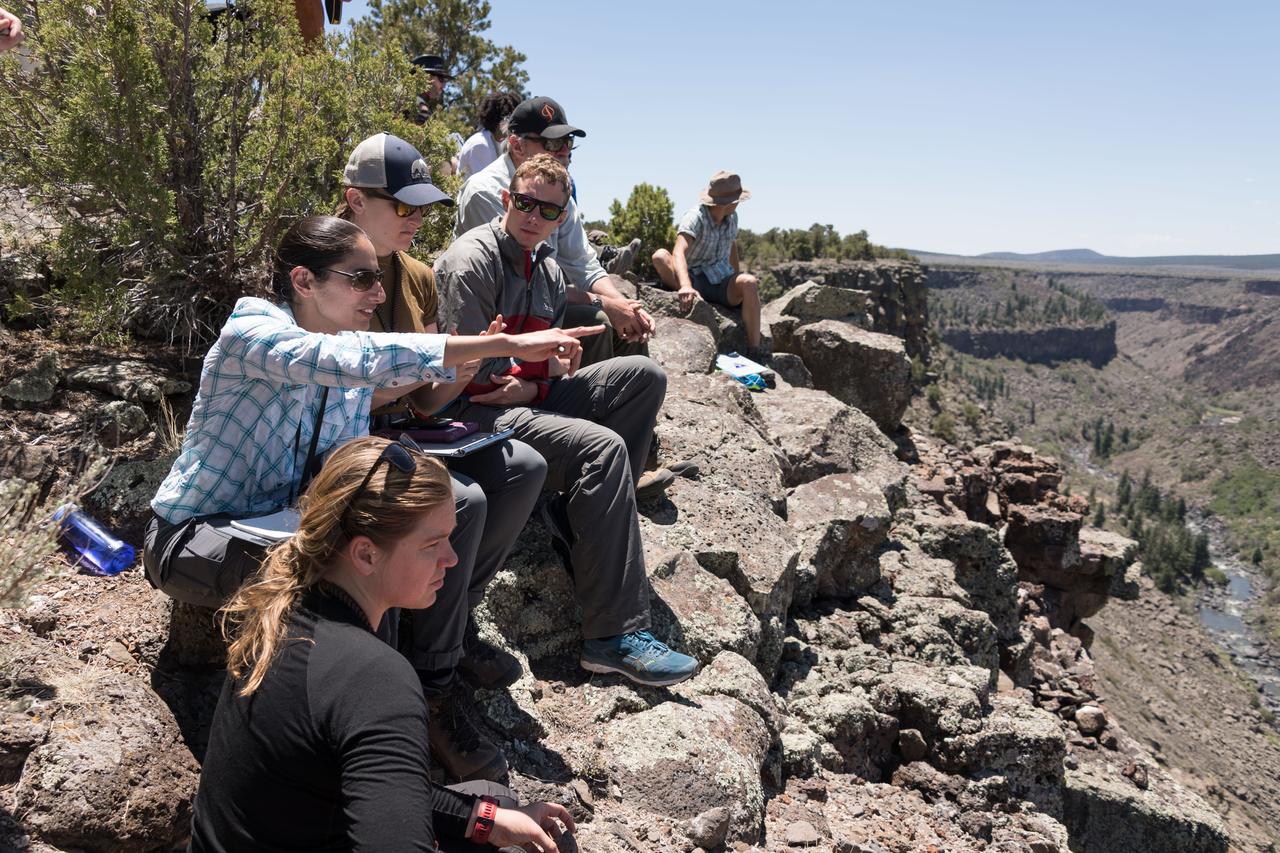 jsc2018e060096 (06/18/2018) --- 2017 NASA astronaut candidates gather together to chart their next location during earth and planetary science training in Rio Grande del Norte National Monument Upper Gorge Area near Questa, N.M. Photo Credit: NASA/Norah Moran