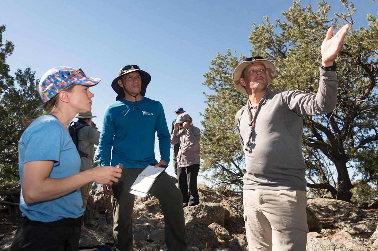 jsc2018e060163 (06/19/2018) --- (L-R) 2017 NASA astronaut candidates (ASCAN) Zena Cardman and Frank Rubio plan for their next location with fellow ASCAN Bob Hines during earth and planetary science training in Rio Grande del Norte National Monument Upper Gorge Area near Questa, N.M. Photo Credit: (NASA/Norah Moran)
