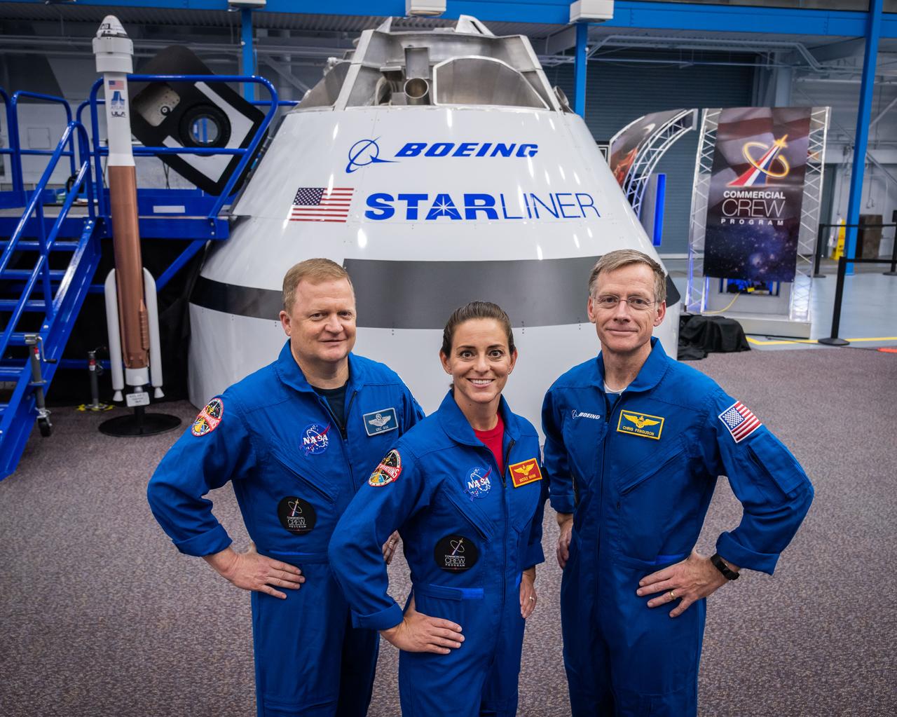 jsc2018e067950 (Aug. 2, 2018) --- NASA astronauts (from left) Eric Boe and Nicole Mann pose with Boeing astronaut Chris Ferguson for a portrait in front of the Boeing CST-100 Starliner Commercial Crew vehicle mock up at NASA's Johnson Space Center in Houston, Texas.