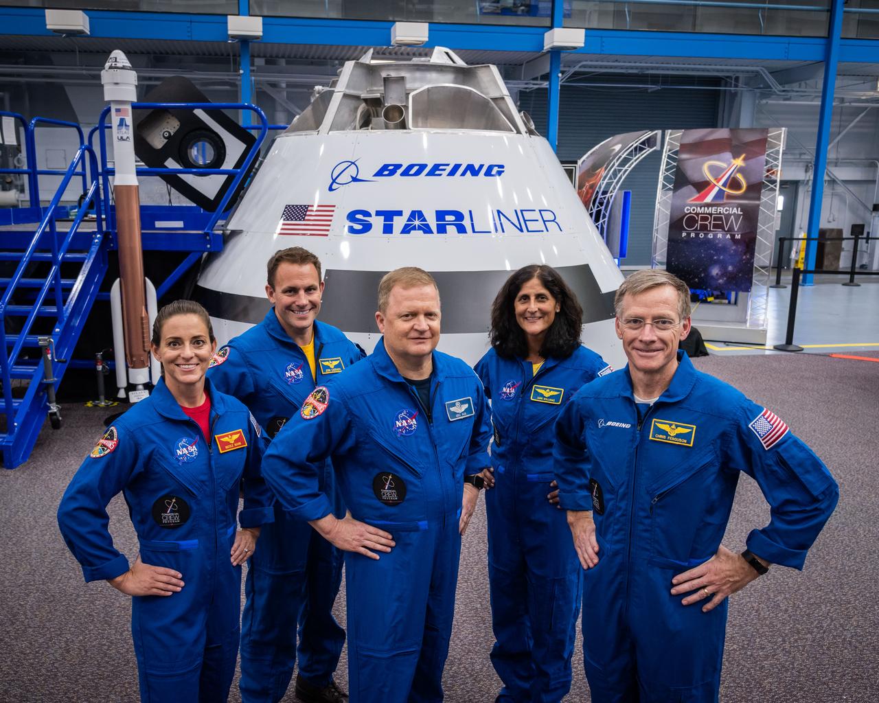 jsc2018e067952 (Aug. 2, 2018) --- NASA astronauts (from left) Nicole Mann, Josh Cassada, Eric Boe and Suni Williams pose with Boeing astronaut Chris Ferguson (far right) for a portrait in front of the Boeing CST-100 Starliner Commercial Crew vehicle mock up at NASA's Johnson Space Center in Houston, Texas.