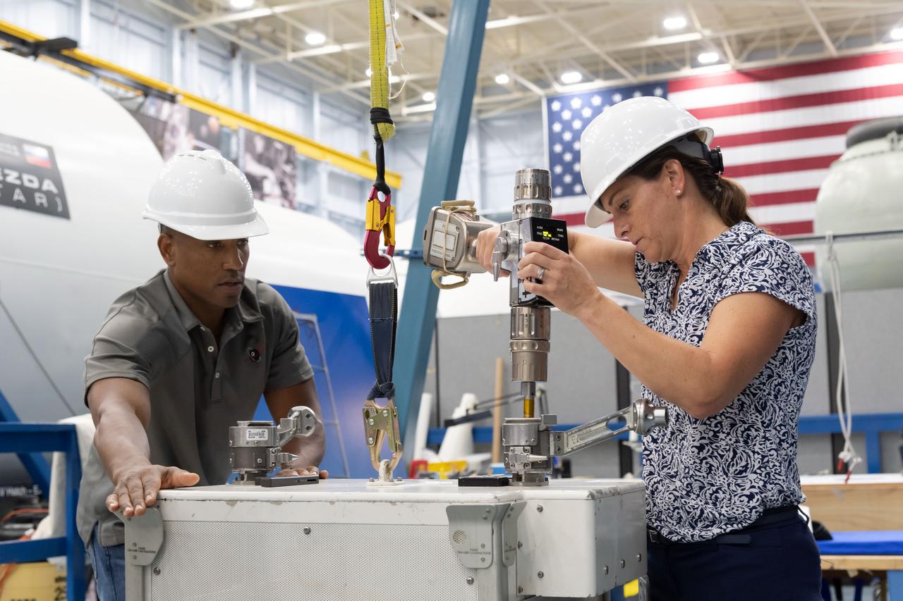 NASA Commercial Crew Program astronauts Nicole Mann and Victor Glover learn about the tools and hardware they will use in spacewalk training at NASA’s Space Vehicle Mockup Facility in Houston. Mann is assigned to launch to the International Space Station on the first crewed flight of Boeing’s CST-100 Starliner. Glover will fly to the station on the second crewed flight of SpaceX’s Crew Dragon.