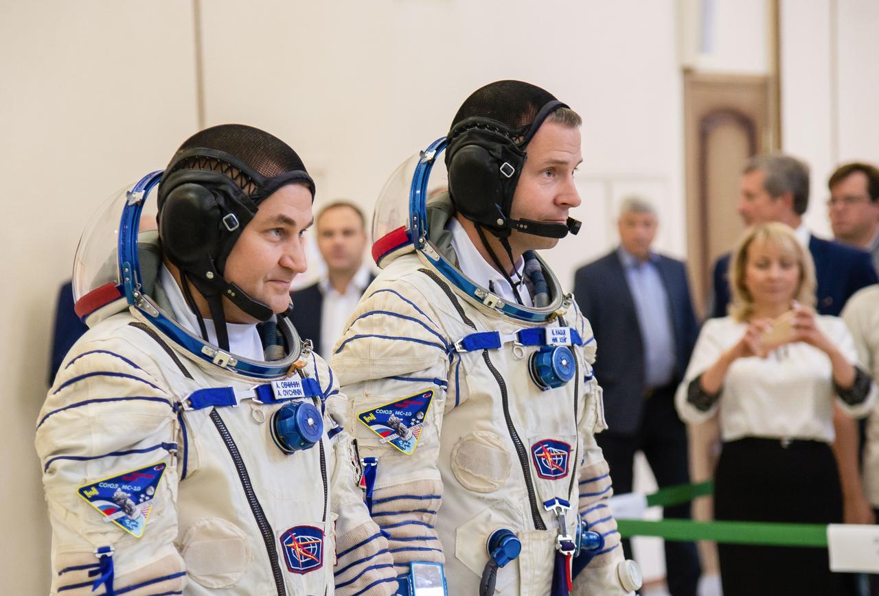 jsc2018e081174 (Sept. 14, 2018) --- At the Gagarin Cosmonaut Training Center in Star City, Russia, Expedition 57 crew members Alexey Ovchinin of Roscosmos (left) and Nick Hague of NASA (right) report to officials Sept. 14 for the second day of their Soyuz qualification exams. They will launch Oct. 11 on the Soyuz MS-10 spacecraft from the Baikonur Cosmodrome in Kazakhstan for a six-month mission on the International Space Station. Credit: NASA/Elizabeth Weissinger.