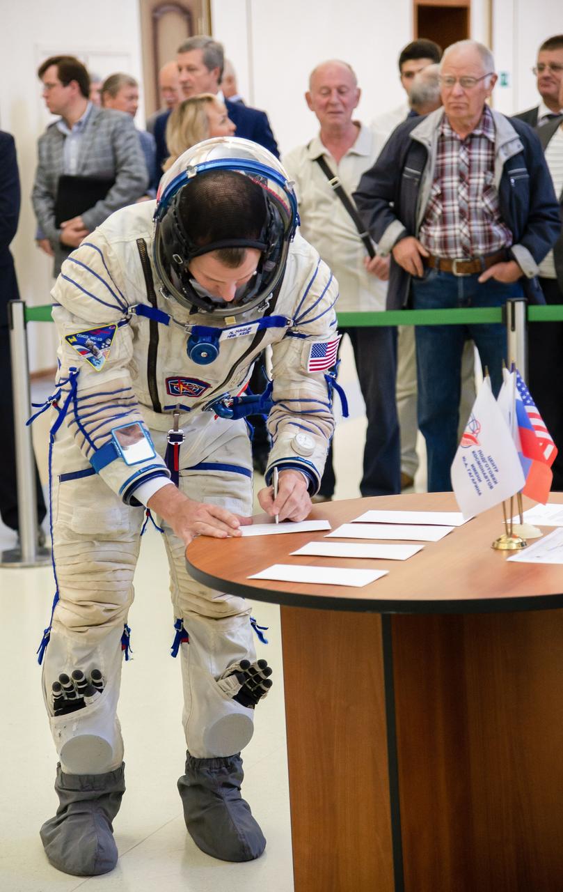 jsc2018e081175 (Sept. 14, 2018) --- At the Gagarin Cosmonaut Training Center in Star City, Russia, Expedition 57 crew member Nick Hague of NASA signs in Sept. 14 for the second day of Soyuz qualification exams. Hague and Alexey Ovchinin of Roscosmos will launch Oct. 11 on the Soyuz MS-10 spacecraft from the Baikonur Cosmodrome in Kazakhstan for a six-month mission on the International Space Station. Credit: NASA/Elizabeth Weissinger.