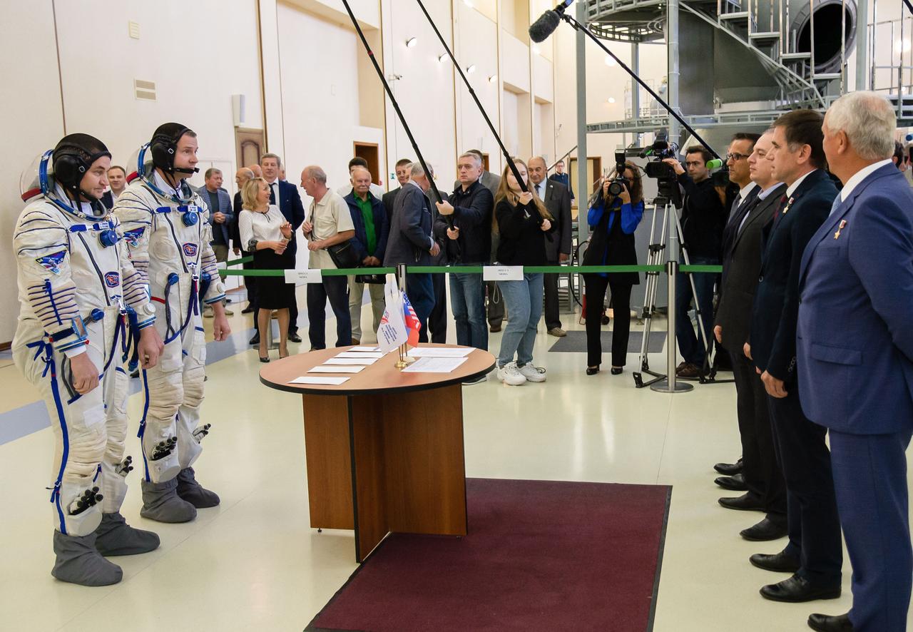 jsc2018e081176 (Sept. 14, 2018) --- At the Gagarin Cosmonaut Training Center in Star City, Russia, Expedition 57 crew members Alexey Ovchinin of Roscosmos (left) and Nick Hague of NASA (right) report to officials Sept. 14 for the second day of their Soyuz qualification exams. They will launch Oct. 11 on the Soyuz MS-10 spacecraft from the Baikonur Cosmodrome in Kazakhstan for a six-month mission on the International Space Station. Credit: NASA/Elizabeth Weissinger.