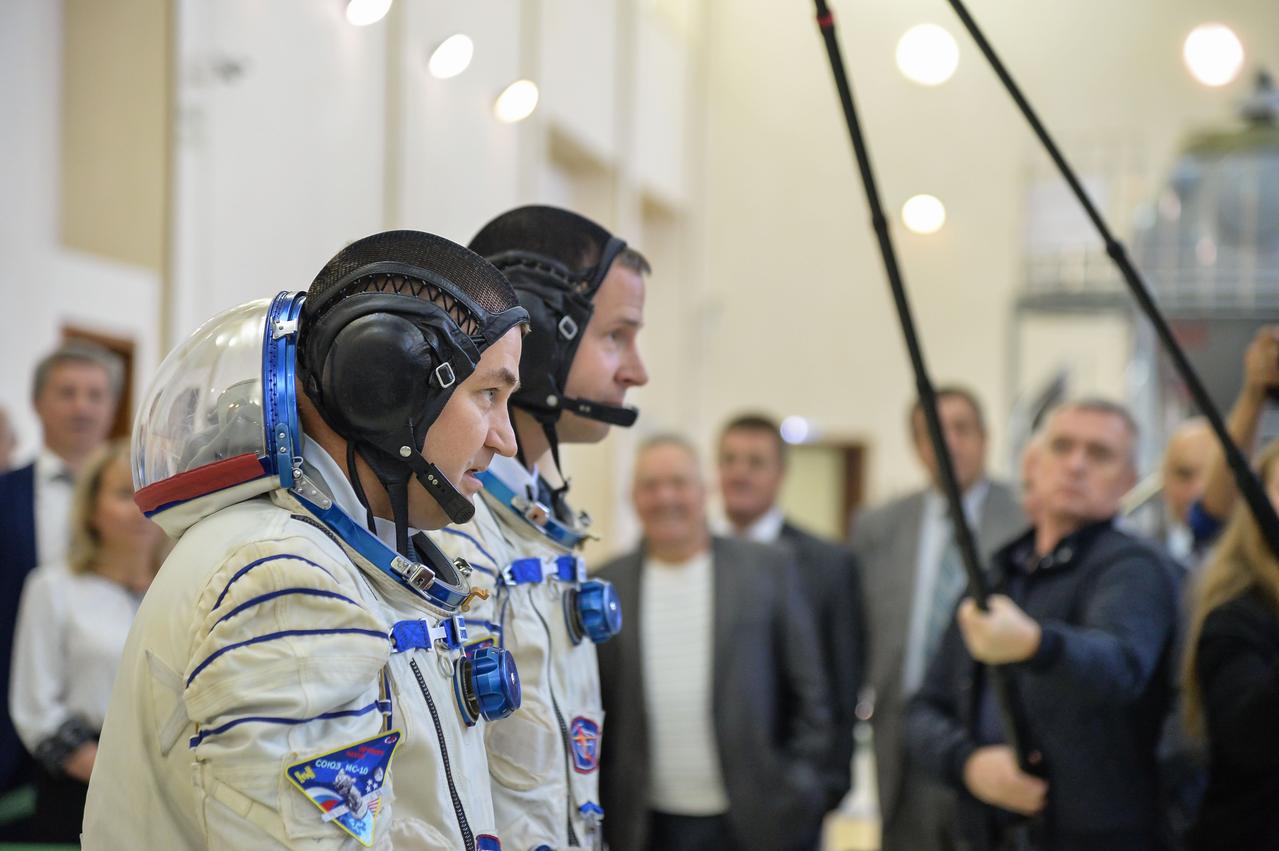 jsc2018e081179 (Sept. 14, 2018) --- At the Gagarin Cosmonaut Training Center in Star City, Russia, Expedition 57 crew members Alexey Ovchinin of Roscosmos (foreground) and Nick Hague of NASA (right) report to officials Sept. 14 for the second day of their Soyuz qualification exams. They will launch Oct. 11 on the Soyuz MS-10 spacecraft from the Baikonur Cosmodrome in Kazakhstan for a six-month mission on the International Space Station. Credit: NASA/Sarah Volkman.