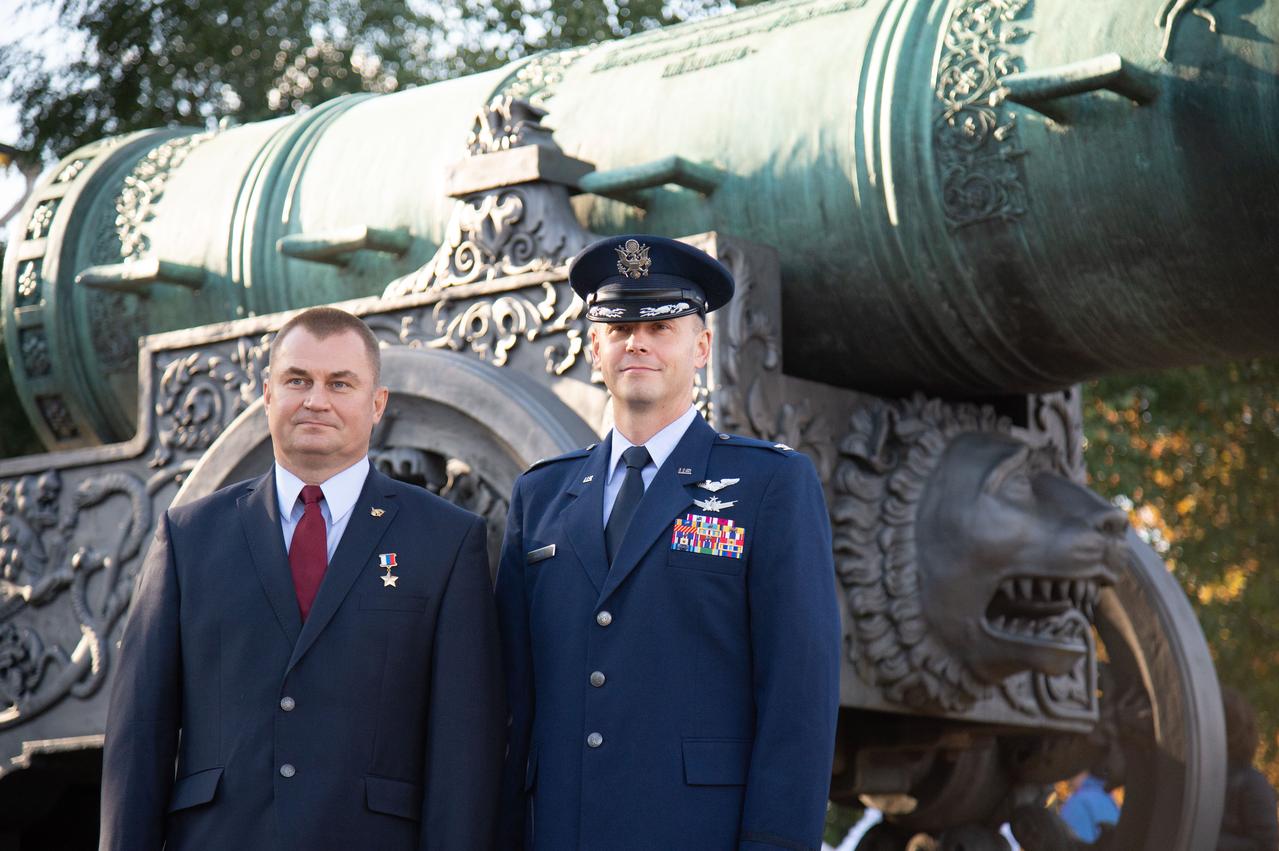 At the Kremlin in Moscow, Expedition 57 crewmembers Alexey Ovchinin of Roscosmos (left) and Nick Hague of NASA (right) pose for pictures in front of the Tsar Bell Sept. 17 as part of traditional prelaunch activities. Hague and Ovchinin will launch Oct. 11 from the Baikonur Cosmodrome in Kazakhstan on the Soyuz MS-10 spacecraft for a six-month mission on the International Space Station...NASA/Elizabeth Weissinger.