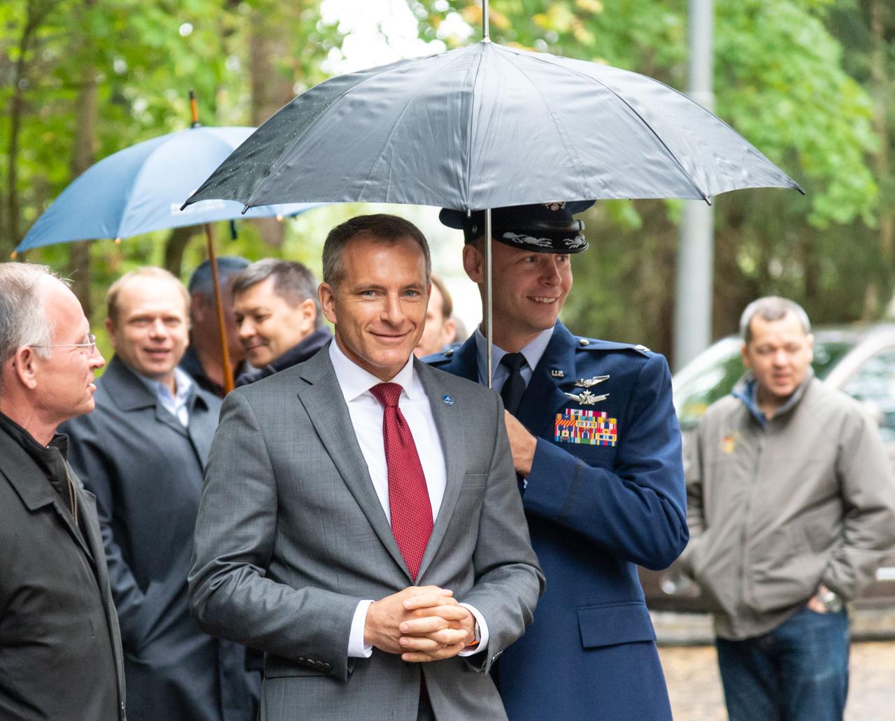 At the Gagarin Cosmonaut Training Center in Star City, Russia, Expedition 57 backup crewmember David Saint-Jacques of the Canadian Space Agency arrives for departure ceremonies Sept. 25, shielded from the rain by prime crewmember Nick Hague of NASA. Hague and Alexey Ovchinin of Roscosmos will launch Oct. 11 from the Baikonur Cosmodrome in Kazakhstan on the Soyuz MS-10 spacecraft for a six-month mission on the International Space Station...NASA/Elizabeth Weissinger.