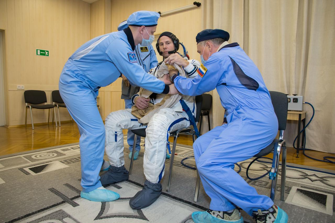 jsc2018e084486 - At the Baikonur Cosmodrome in Kazakhstan, Expedition 57 crewmember Nick Hague of NASA suits up in a Russian Sokol launch and entry suit Sept. 26 as part of pre-launch training. Hague and Alexey Ovchinin of Roscosmos will launch Oct. 11 in the Soyuz MS-10 spacecraft from the Baikonur Cosmodrome for a six-month mission on the International Space Station...NASA/Victor Zelentsov.