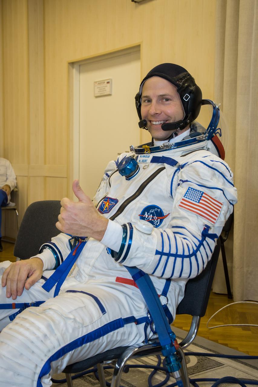 jsc2018e084487 - At the Baikonur Cosmodrome in Kazakhstan, Expedition 57 crewmember Nick Hague of NASA flashes a thumbs up sign in his Russian Sokol launch and entry suit Sept. 26 during pre-launch training activities. Hague and Alexey Ovchinin of Roscosmos will launch Oct. 11 in the Soyuz MS-10 spacecraft from the Baikonur Cosmodrome for a six-month mission on the International Space Station...NASA/Victor Zelentsov.
