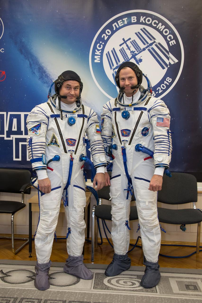 jsc2018e084490 - At the Baikonur Cosmodrome in Kazakhstan, Expedition 57 crewmembers Alexey Ovchinin of Roscosmos (left) and Nick Hague of NASA (right) pose for pictures in their Russian Sokol launch and entry suits Sept. 26 as part of pre-launch training activities. They will launch Oct. 11 in the Soyuz MS-10 spacecraft from the Baikonur Cosmodrome for a six-month mission on the International Space Station...NASA/Victor Zelentsov.