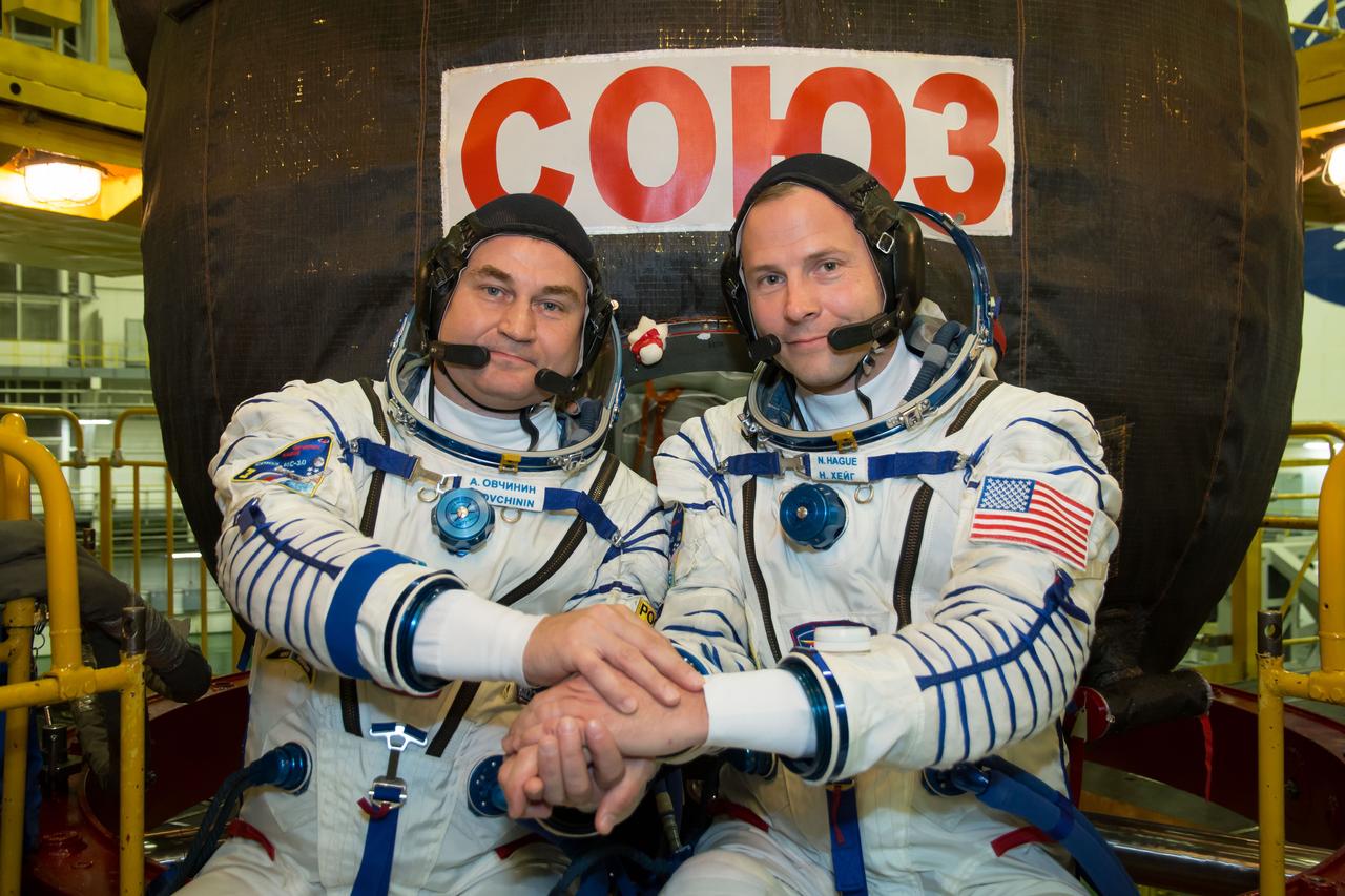 jsc2018e084492 - At the Baikonur Cosmodrome in Kazakhstan, Expedition 57 crewmembers Alexey Ovchinin of Roscosmos (left) and Nick Hague of NASA (right) pose for pictures in front of their Soyuz MS-10 spacecraft Sept. 26 during final pre-launch training. Ovchinin and Hague will launch Oct. 11 in the Soyuz MS-10 from the Baikonur Cosmodrome for a six-month mission on the International Space Station...NASA/Victor Zelentsov.