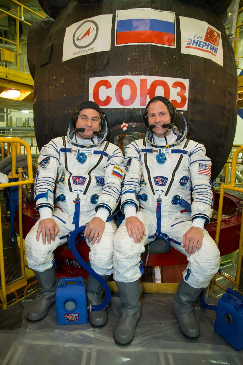 jsc2018e084493 - At the Baikonur Cosmodrome in Kazakhstan, Expedition 57 crewmembers Alexey Ovchinin of Roscosmos (left) and Nick Hague of NASA (right) pose for pictures in front of their Soyuz MS-10 spacecraft Sept. 26 during final pre-launch training. Ovchinin and Hague will launch Oct. 11 in the Soyuz MS-10 from the Baikonur Cosmodrome for a six-month mission on the International Space Station...NASA/Victor Zelentsov.