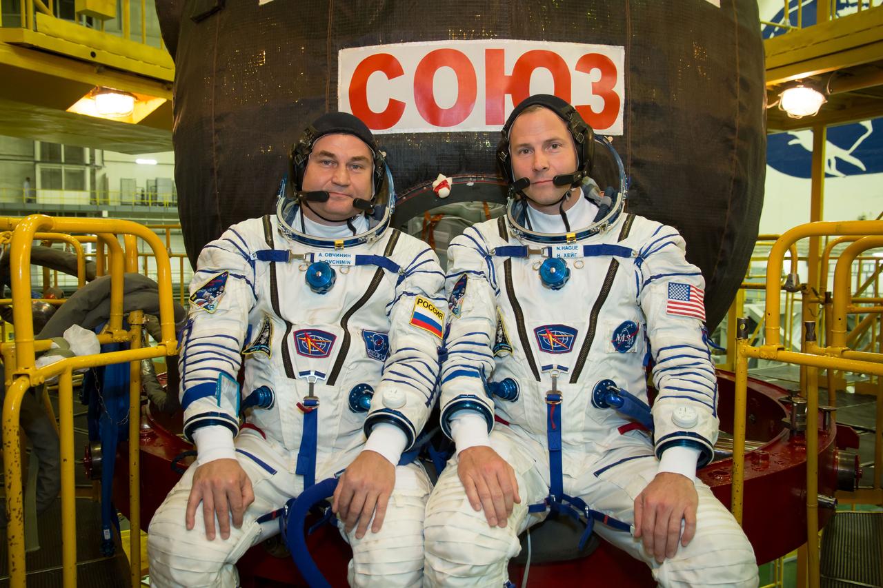 jsc2018e084494 - At the Baikonur Cosmodrome in Kazakhstan, Expedition 57 crewmembers Alexey Ovchinin of Roscosmos (left) and Nick Hague of NASA (right) pose for pictures in front of their Soyuz MS-10 spacecraft Sept. 26 during final pre-launch training. Ovchinin and Hague will launch Oct. 11 in the Soyuz MS-10 from the Baikonur Cosmodrome for a six-month mission on the International Space Station...NASA/Victor Zelentsov.