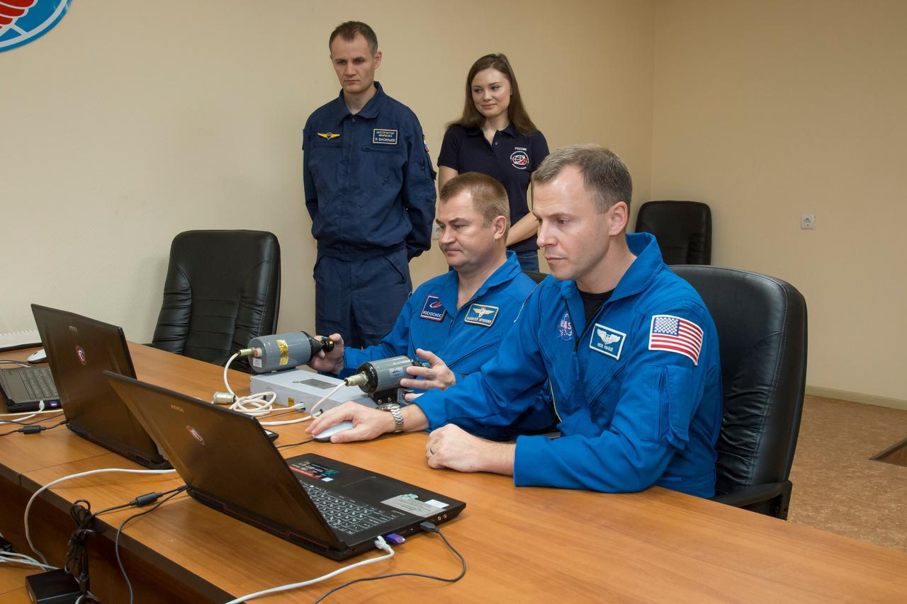 jsc2018e085890 (Oct. 3, 2018) --- Expedition 57 crew members Alexey Ovchinin of Roscosmos, left, and Nick Hague of NASA, right, conduct rendezvous and docking procedures on a laptop training simulator as part of their pre-launch preparations, Wednesday, Oct. 3, 2018 at the Cosmonaut Hotel in Baikonur, Kazakhstan. Ovchinin and Hague are scheduled to launch on Oct. 11 onboard the Soyuz MS-10 spacecraft from the Baikonur Cosmodrome in Kazakhstan for a six-month mission on the International Space Station. Photo Credit: (NASA/Victor Zelentsov)