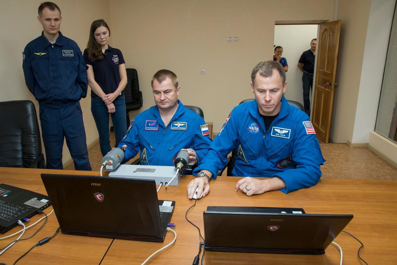 jsc2018e085891 (Oct. 3, 2018) --- Expedition 57 crew members Alexey Ovchinin of Roscosmos, left, and Nick Hague of NASA, right, conduct rendezvous and docking procedures on a laptop training simulator as part of their pre-launch preparations, Wednesday, Oct. 3, 2018 at the Cosmonaut Hotel in Baikonur, Kazakhstan. Ovchinin and Hague are scheduled to launch on Oct. 11 onboard the Soyuz MS-10 spacecraft from the Baikonur Cosmodrome in Kazakhstan for a six-month mission on the International Space Station. Photo Credit: (NASA/Victor Zelentsov)