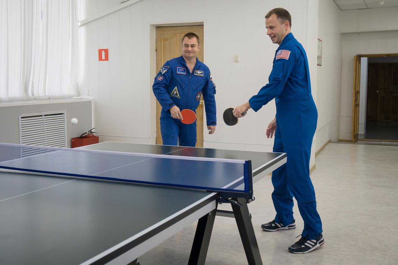 jsc2018e085898 (Oct. 3, 2018) --- Expedition 57 crew members Alexey Ovchinin of Roscosmos, left, and Nick Hague of NASA, right, play a game of ping-pong as part of the traditional pre-launch activities, Wednesday, Oct. 3, 2018 at the Cosmonaut Hotel in Baikonur, Kazakhstan. Ovchinin and Hague are scheduled to launch on Oct. 11 onboard the Soyuz MS-10 spacecraft from the Baikonur Cosmodrome in Kazakhstan for a six-month mission on the International Space Station. Photo Credit: (NASA/Victor Zelentsov)