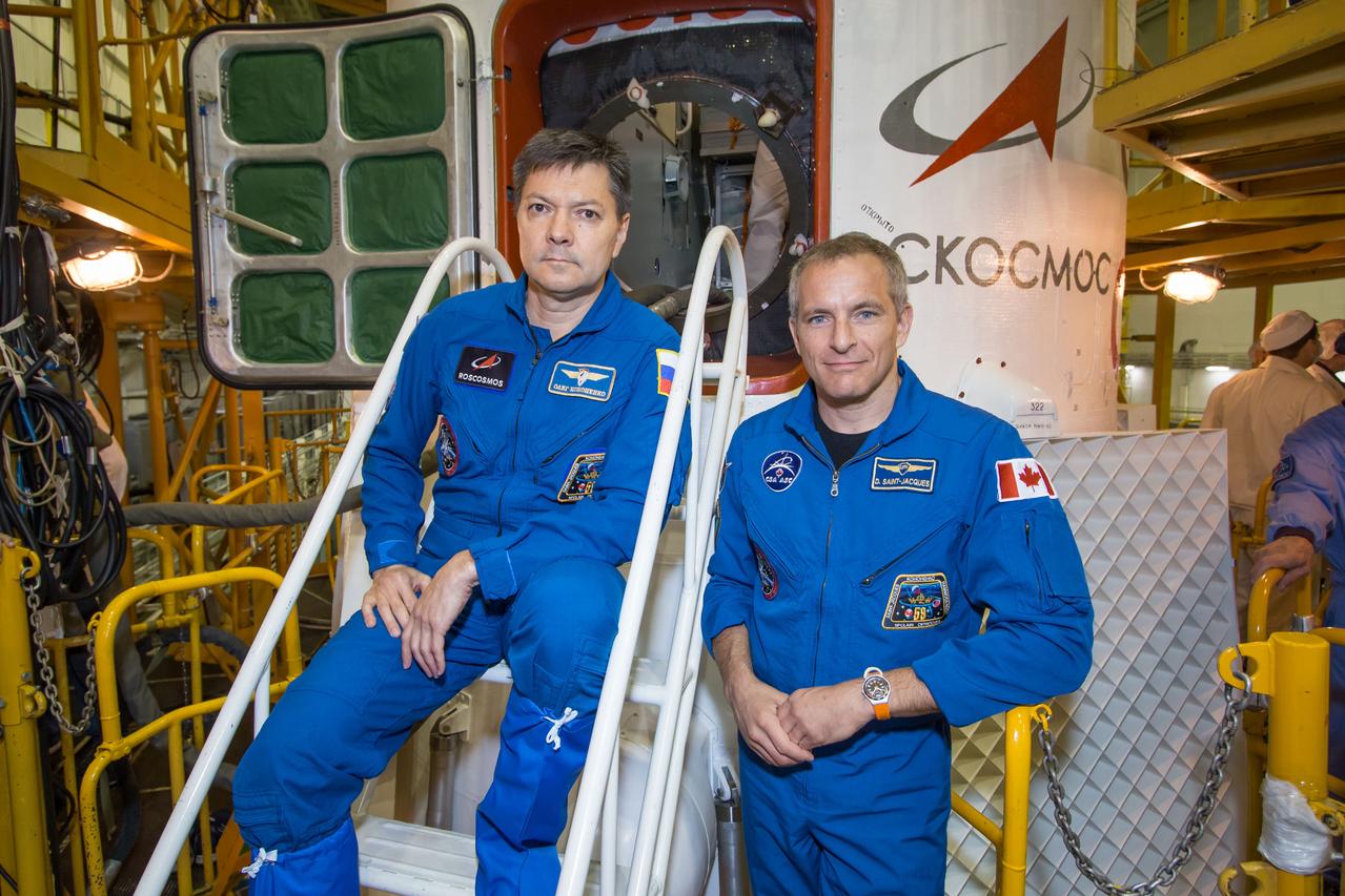 At the Baikonur Cosmodrome in Kazakhstan, Expedition 57 backup crewmembers Oleg Kononenko of Roscosmos (left) and David Saint-Jacques of the Canadian Space Agency (right) pose for pictures Oct. 6 in front of the Soyuz MS-10 spacecraft. They are the backups to the prime crewmembers, Alexey Ovchinin of Roscosmos and Nick Hague of NASA, who will launch Oct. 11 from the Baikonur Cosmodrome on the Soyuz MS-10 spacecraft for a six-month mission on the International Space Station...NASA/Victor Zelentsov.