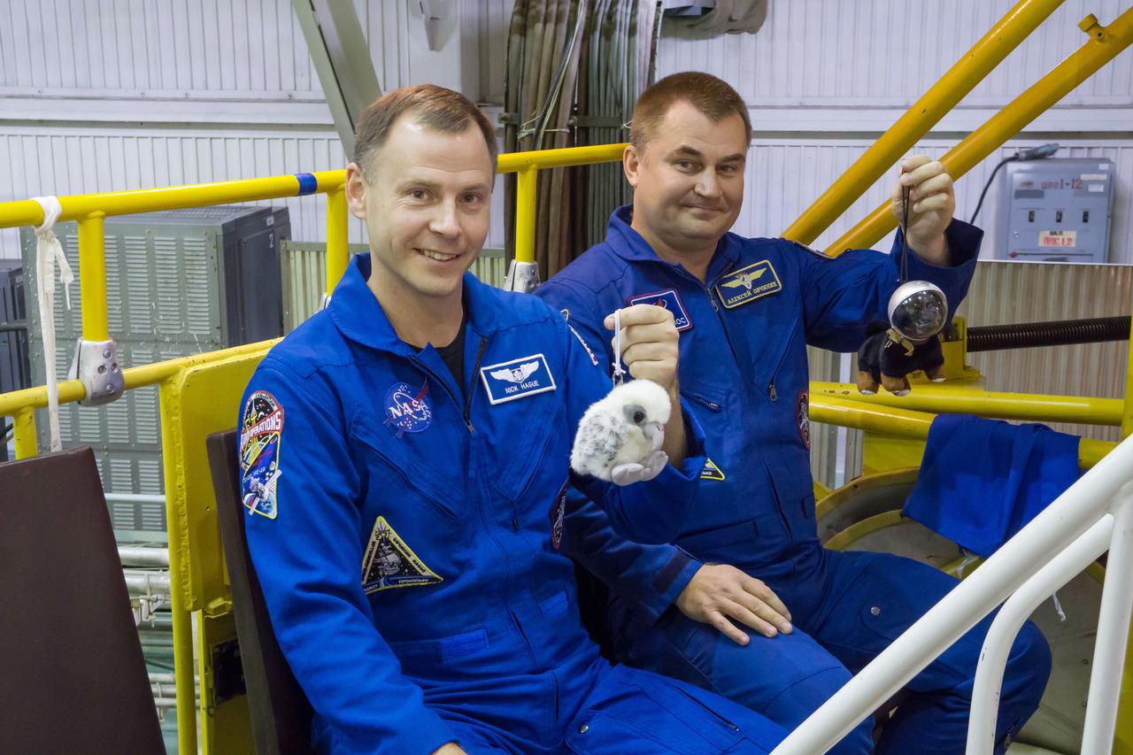 At the Baikonur Cosmodrome in Kazakhstan, Expedition 57 crewmembers Nick Hague of NASA (left) and Alexey Ovchinin of Roscosmos (right) hold up toy mascots Oct. 6 during final fit check activities prior to launch. The mascots will be mounted over their heads in the Soyuz MS-10 spacecraft to serve as “zero-G” indicators when they launch Oct. 11 for a six-month mission on the International Space Station...NASA/Victor Zelentsov.