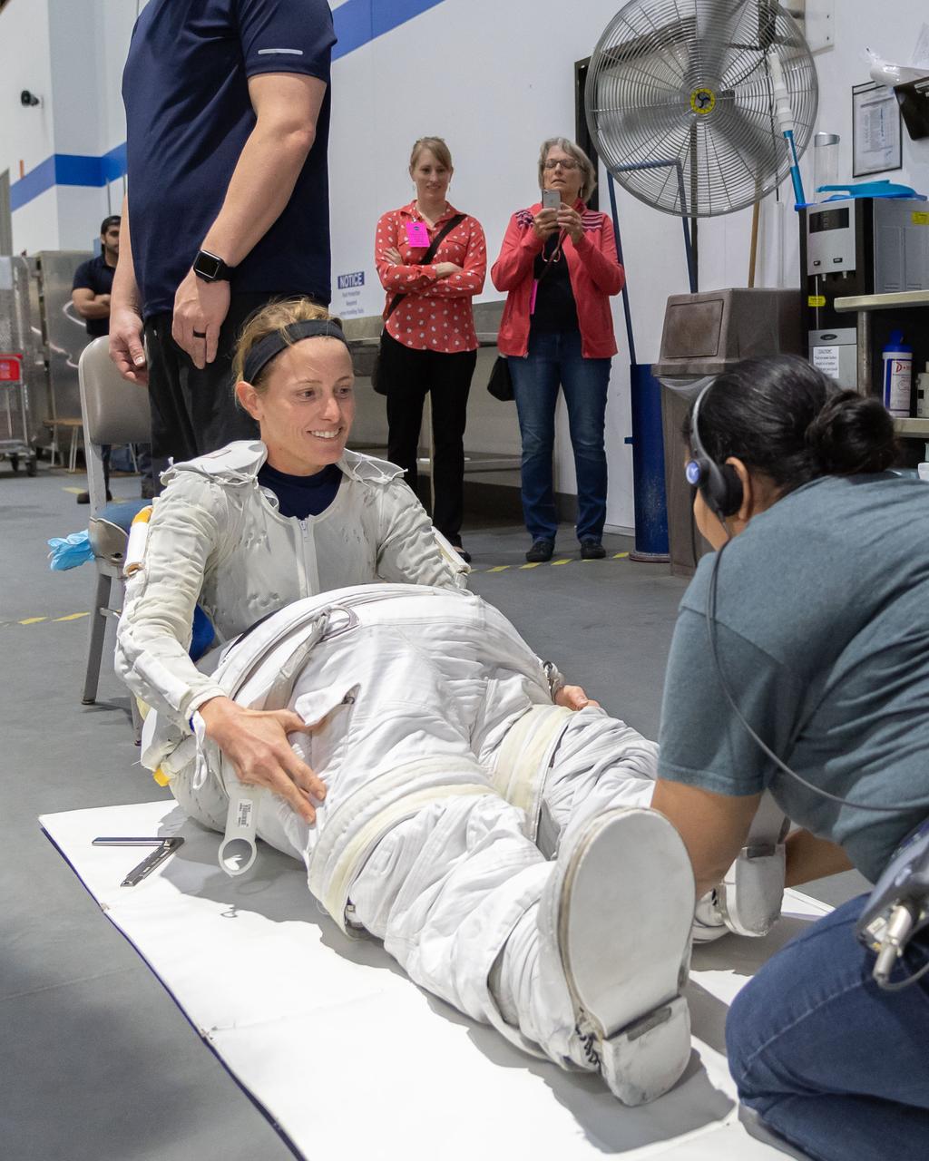 jsc2018e094712 (November 05, 2018) --- 2017 NASA astronaut candidate Loral O’Hara wears a Liquid Cooling and Ventilation Garment and is helped into a spacesuit prior to underwater spacewalk training at NASA Johnson Space Center’s Neutral Buoyancy Laboratory in Houston. The cooling garment distributes water throughout to help keep her cool while training underwater in the spacesuit. Photo Credit: (NASA/Josh Valcarcel)