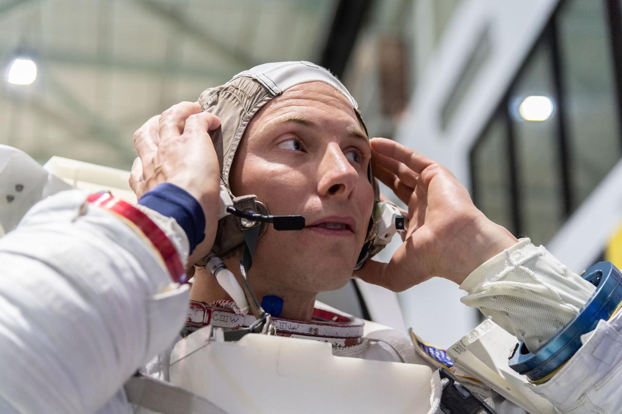 jsc2018e094721 (November 05, 2018) --- 2017 NASA astronaut candidate Warren Hoburg wears a spacesuit prior to underwater spacewalk training at NASA Johnson Space Center’s Neutral Buoyancy Laboratory in Houston. Photo Credit: (NASA/Josh Valcarcel)