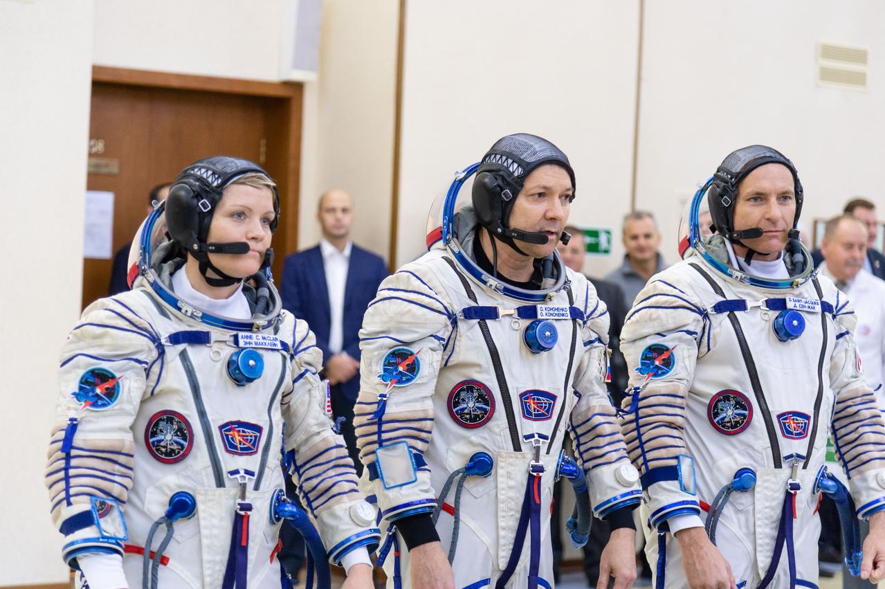 jsc2018e095175 - At the Gagarin Cosmonaut Training Center in Star City, Russia, Expedition 58 crewmembers Anne McClain of NASA (left), Oleg Kononenko of Roscosmos (center) and David Saint-Jacques of the Canadian Space Agency (right) report to Russian space officials Nov. 14 for their final day of qualification exams. They will launch Dec. 3 on the Soyuz MS-11 spacecraft from the Baikonur Cosmodrome in Kazakhstan for a six-and-a-half month mission on the International Space Station...NASA/Sarah Volkman.