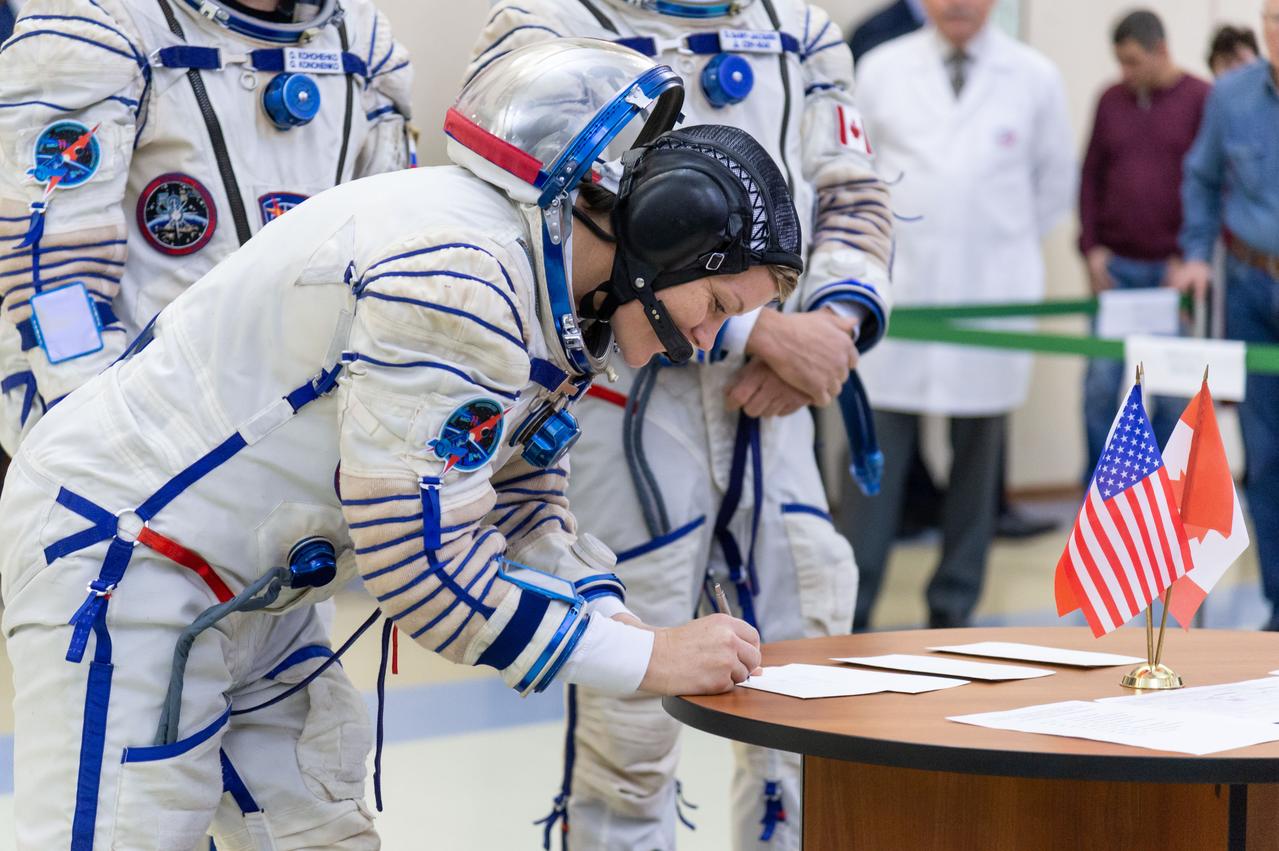 jsc2018e095177 - At the Gagarin Cosmonaut Training Center in Star City, Russia, Expedition 58 crewmember Anne McClain of NASA signs in for the final day of qualification exams Nov. 14. McClain, David Saint-Jacques of the Canadian Space Agency and Oleg Kononenko of Roscosmos will launch Dec. 3 on the Soyuz MS-11 spacecraft from the Baikonur Cosmodrome in Kazakhstan for a six-and-a-half month mission on the International Space Station...NASA/Sarah Volkman.