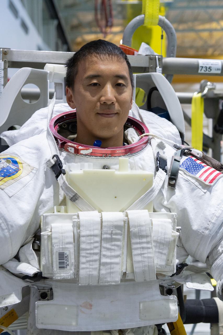 jsc2018e095903 (November 7, 2018) --- 2017 NASA astronaut candidate Jonny Kim wears a spacesuit prior to underwater spacewalk training at NASA Johnson Space Center’s Neutral Buoyancy Laboratory in Houston. Photo Credit: (NASA/Robert Markowitz)