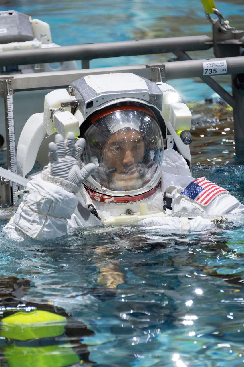 jsc2018e095941 (November 7, 2018) --- 2017 NASA astronaut candidate Jonny Kim is lowered into the training pool for spacewalk training at NASA Johnson Space Center’s Neutral Buoyancy Laboratory in Houston. Photo Credit: (NASA/Robert Markowitz)