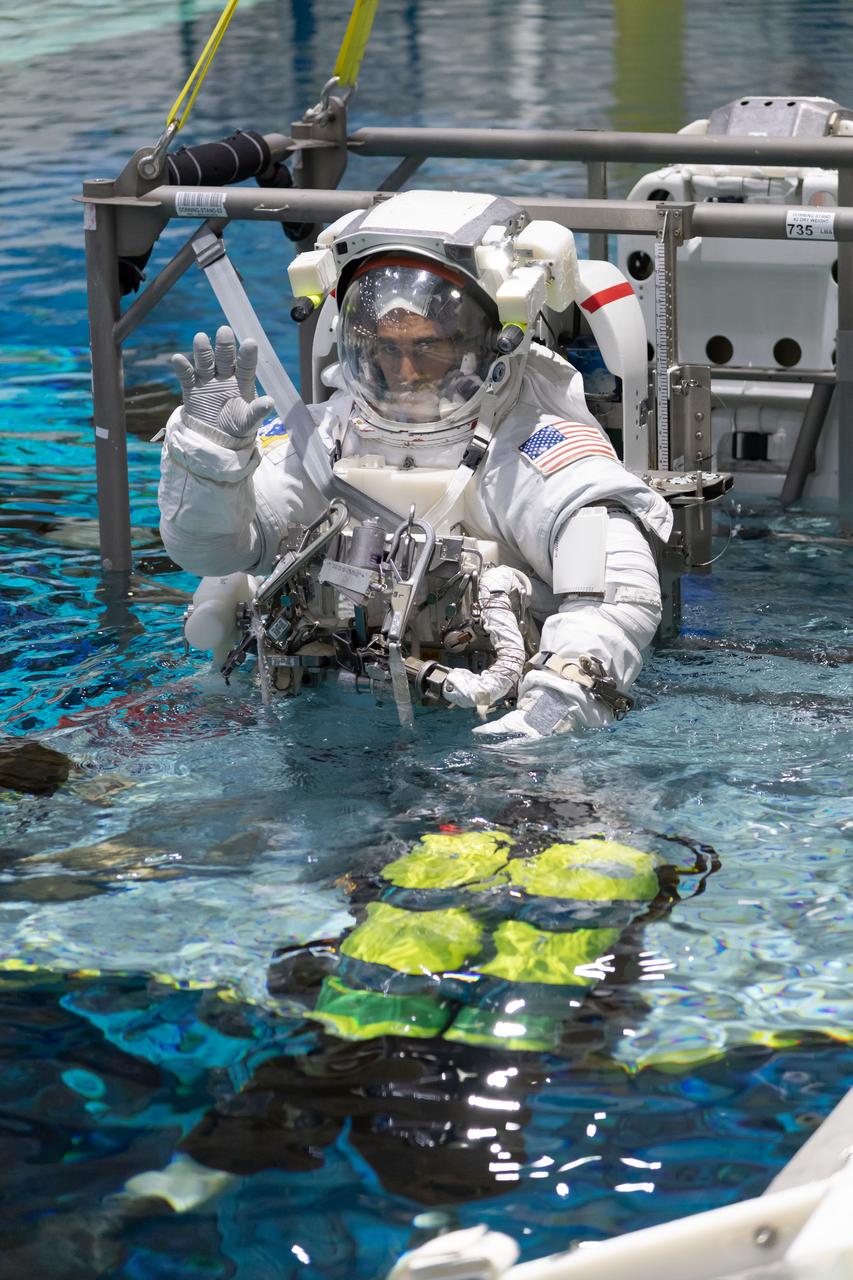 jsc2018e096694 (November 16, 2018) --- 2017 NASA astronaut candidate Raja Chari is lowered into the training pool for spacewalk training at NASA Johnson Space Center’s Neutral Buoyancy Laboratory in Houston. Photo Credit: (NASA/Robert Markowitz)