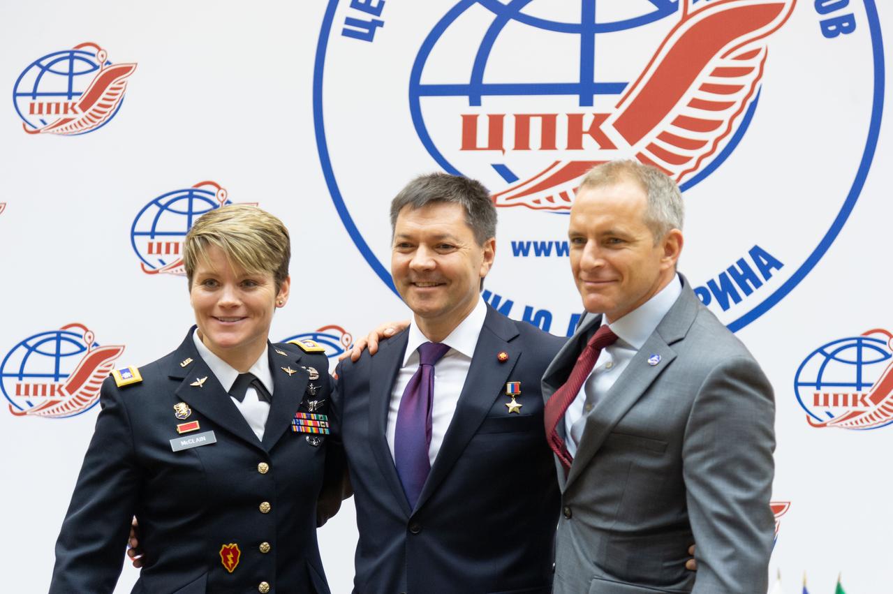 At the Gagarin Cosmonaut Training Center in Star City, Russia, Expedition 58 crewmembers Anne McClain of NASA (left), Oleg Kononenko of Roscosmos (center) and David Saint-Jacques of the Canadian Space Agency (right) pose for pictures Nov. 15 following the crew’s news conference. They will launch Dec. 3 on the Soyuz MS-11 spacecraft from the Baikonur Cosmodrome in Kazakhstan for a six-and-a-half month mission on the International Space Station...NASA/Sarah Volkman.
