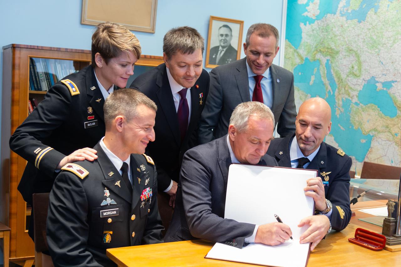 At the Gagarin Museum at the Gagarin Cosmonaut Training Center in Star City, Russia, Expedition 58 backup crewmembers Drew Morgan of NASA (front row, left), Alexander Skvortsov of Roscosmos (front row, center) and Luca Parmitano of the European Space Agency (front row, right) sign a book bearing crews’ signatures in a traditional ceremony Nov. 15. Looking on in the back row are the prime crewmembers, Anne McClain of NASA (left), Oleg Kononenko of Roscosmos (center) and David Saint-Jacques of the Canadian Space Agency (right), who will launch Dec. 3 on the Soyuz MS-11 spacecraft from the Baikonur Cosmodrome in Kazakhstan for a six-and-a-half month mission on the International Space Station...NASA/Sarah Volkman.