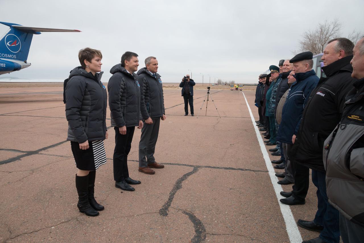 jsc2018e097263 - Expedition 58 crewmembers Anne McClain of NASA (left), Oleg Kononenko of Roscosmos (center) and David Saint-Jacques of the Canadian Space Agency (right) report to Russian space officials Nov. 19 after arriving at their launch site in Baikonur, Kazakhstan for final pre-launch training. They will launch Dec. 3 on the Soyuz MS-11 spacecraft from the Baikonur Cosmodrome in Kazakhstan for a six-and-a-half month mission on the International Space Station...NASA/Victor Zelentsov.