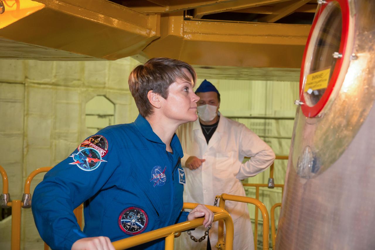 jsc2018e097290 - In the Integration Facility at the Baikonur Cosmodrome in Kazakhstan, Expedition 58 crewmember Anne McClain of NASA prepares to board her Soyuz spacecraft Nov. 20 during a vehicle fit check. McClain, Oleg Kononenko of Roscosmos and David Saint-Jacques of the Canadian Space Agency will launch Dec. 3 on the Soyuz MS-11 spacecraft from the Baikonur Cosmodrome for a six-and-a-half month mission on the International Space Station...NASA/Victor Zelentsov.