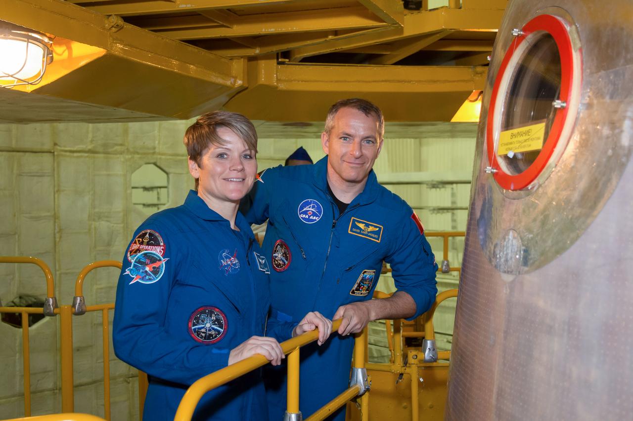 jsc2018e097291 - In the Integration Facility at the Baikonur Cosmodrome in Kazakhstan, Expedition 58 crewmembers Anne McClain of NASA (left) and David Saint-Jacques of the Canadian Space Agency (right) pose for pictures outside their Soyuz spacecraft Nov. 20 during a vehicle fit check. McClain, Saint-Jacques and Oleg Kononenko of Roscosmos will launch Dec. 3 on the Soyuz MS-11 spacecraft from the Baikonur Cosmodrome for a six-and-a-half month mission on the International Space Station...NASA/Victor Zelentsov.