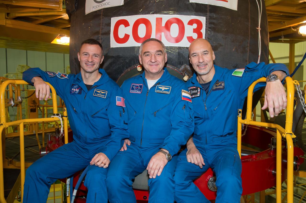jsc2018e097292 - In the Integration Facility at the Baikonur Cosmodrome in Kazakhstan, Expedition 58 backup crewmembers Drew Morgan of NASA (left), Alexander Skvortsov of Roscosmos (center) and Luca Parmitano of the European Space Agency (right) pose for pictures Nov. 20 in front of the Soyuz MS-11 spacecraft during a vehicle fit check. They are the backups to prime crewmembers Anne McClain of NASA, Oleg Kononenko of Roscosmos and David Saint-Jacques of the Canadian Space Agency, who will launch Dec. 3 on the Soyuz MS-11 spacecraft from the Baikonur Cosmodrome for a six-and-a-half month mission on the International Space Station...NASA/Victor Zelentsov.