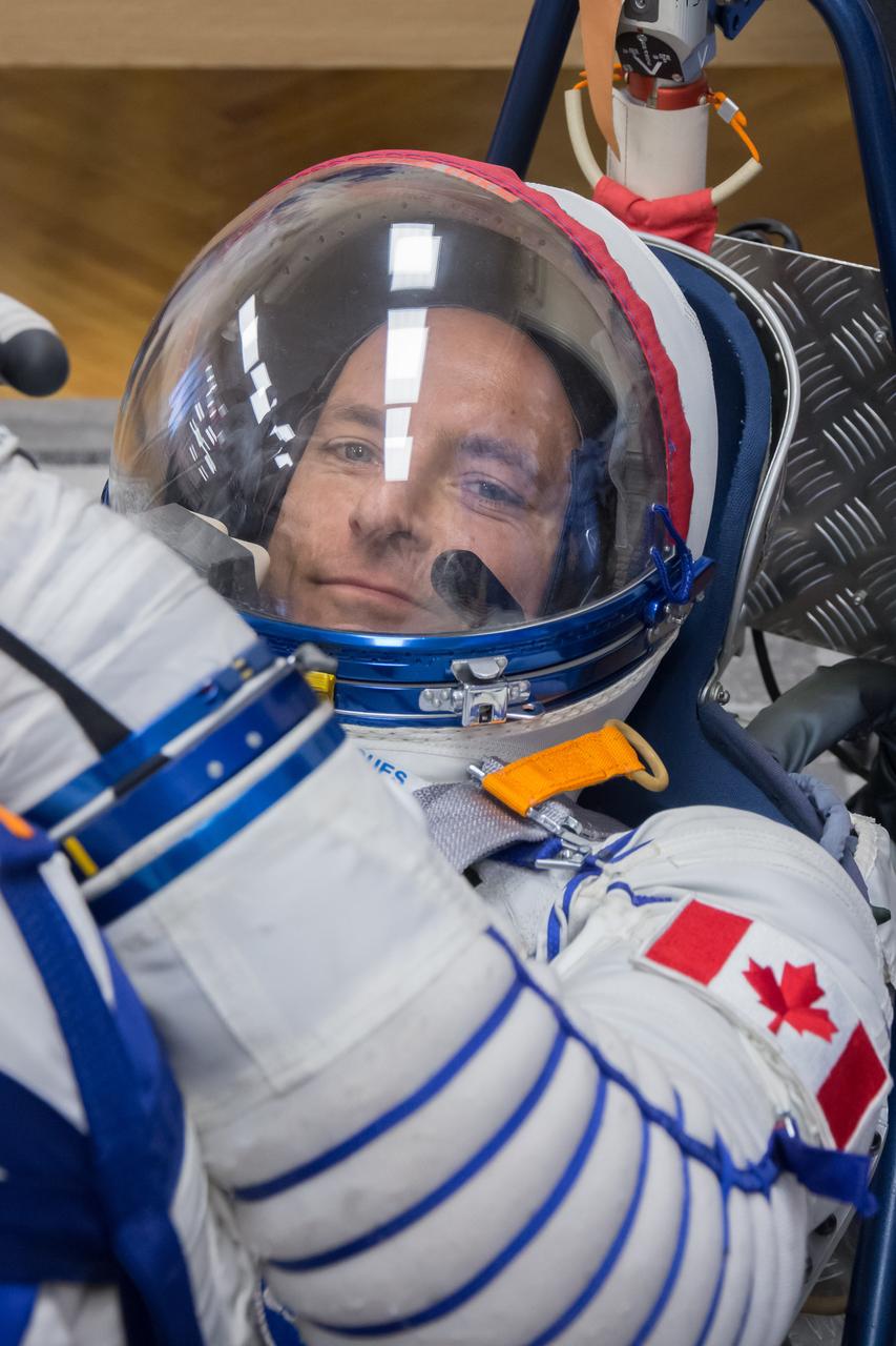 jsc2018e097294 - In the Integration Facility at the Baikonur Cosmodrome in Kazakhstan, Expedition 58 crewmember David Saint-Jacques of the Canadian Space Agency smiles during a Russian Sokol launch and entry suit pressure and leak check Nov. 20. Saint-Jacques, Anne McClain of NASA and Oleg Kononenko of Roscosmos will launch Dec. 3 on the Soyuz MS-11 spacecraft from the Baikonur Cosmodrome for a six-and-a-half month mission on the International Space Station...NASA/Victor Zelentsov.