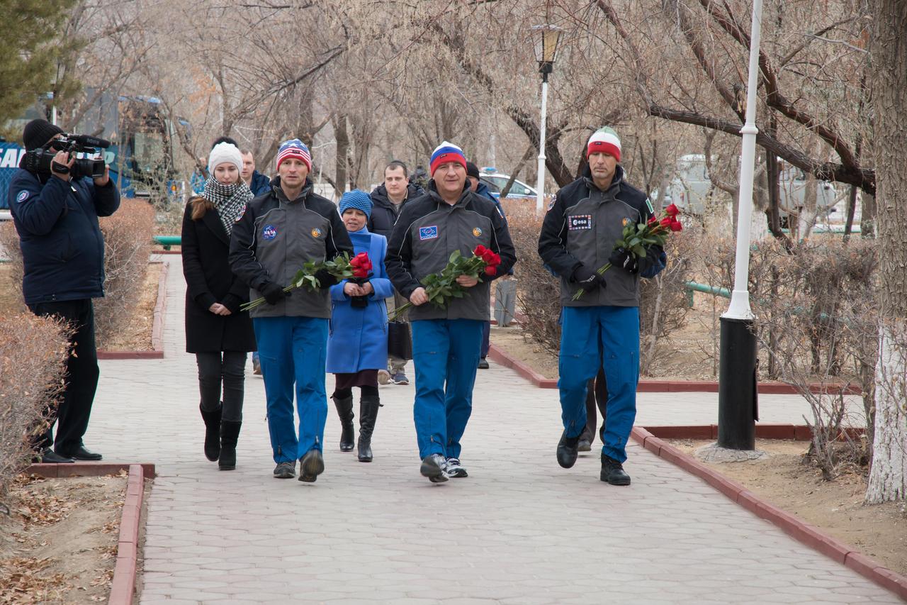 jsc2018e097313 - In the town of Baikonur, Kazakhstan, Expedition 58 backup crewmembers Drew Morgan of NASA (left), Alexander Skvortsov of Roscosmos and Luca Parmitano of the European Space Agency walk toward the statue of Yuri Gagarin, the first human to fly in space Nov. 21 as they prepare to lay flowers at the statue in a traditional ceremony. They are the backups to Anne McClain of NASA, Oleg Kononenko of Roscosmos and David Saint-Jacques of the Canadian Space Agency, who will launch Dec. 3 on the Soyuz MS-11 spacecraft from the Baikonur Cosmodrome in Kazakhstan for a six-and-a-half month mission on the International Space Station...NASA/Victor Zelentsov.